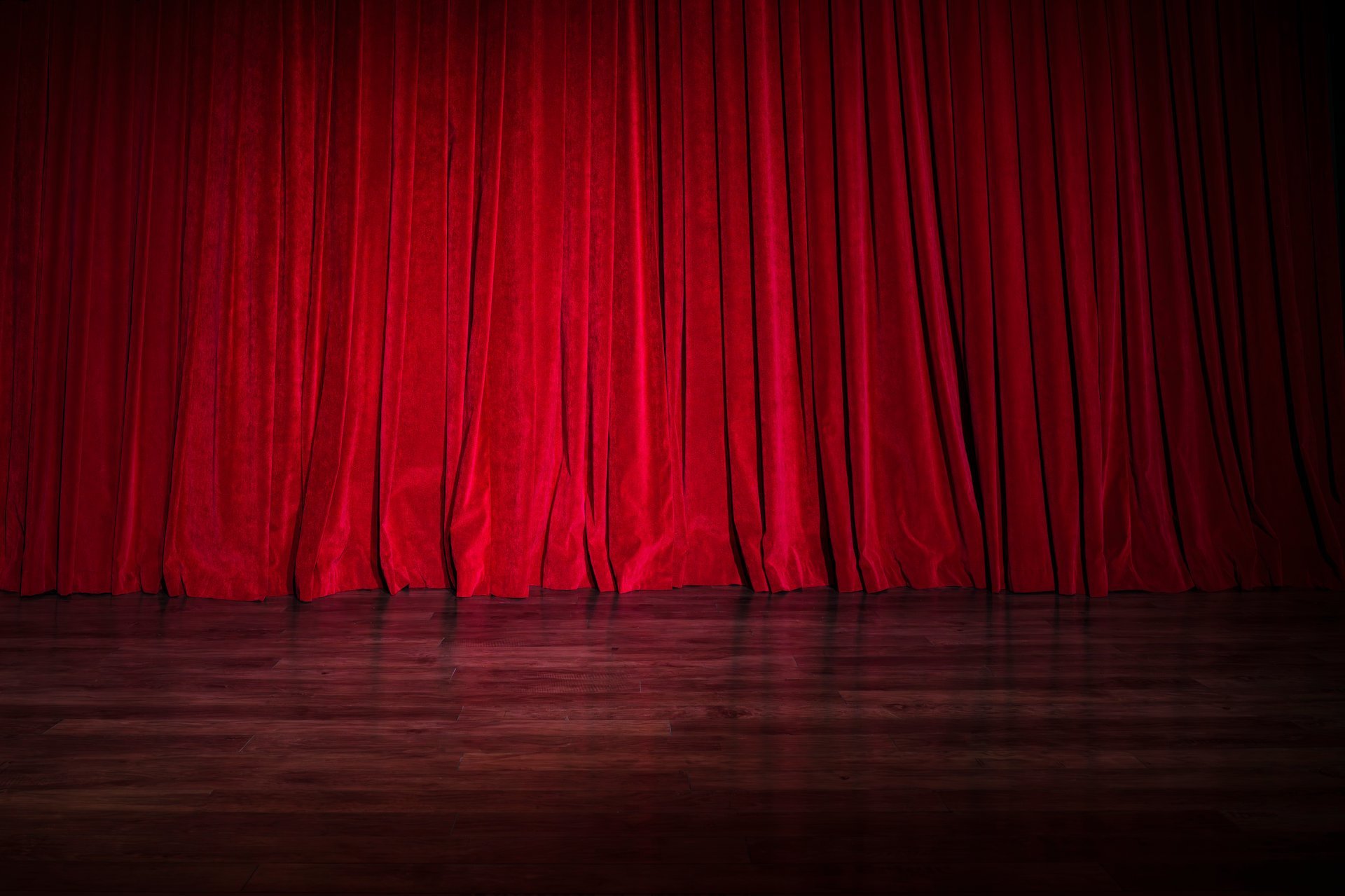 Dramatic red curtain in empty performance hall