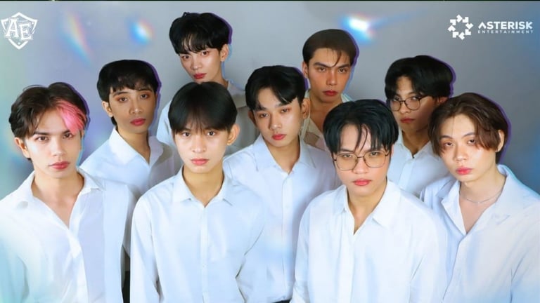 Eight members of K-pop group ASTERISK pose together wearing matching white shirts against a blue gradient background